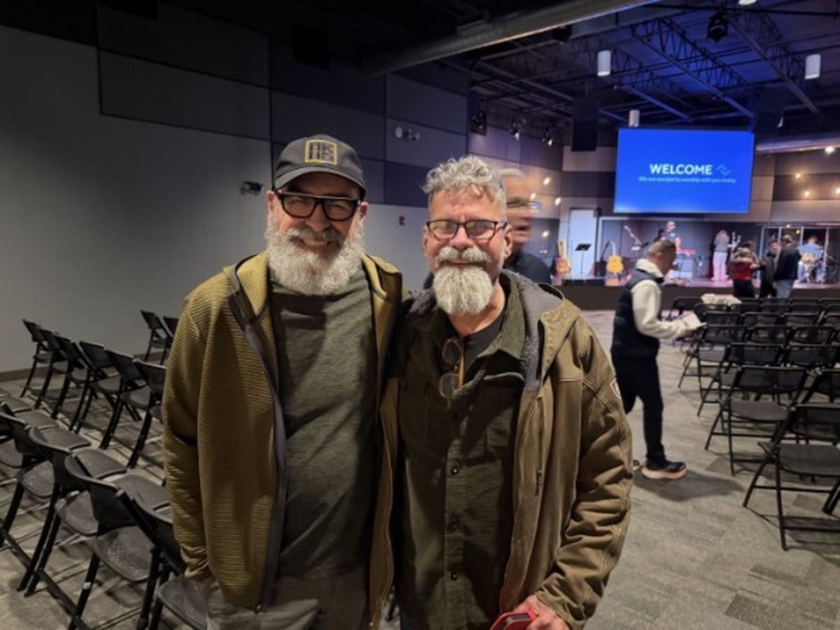 Two friends together at the gathering before service begins